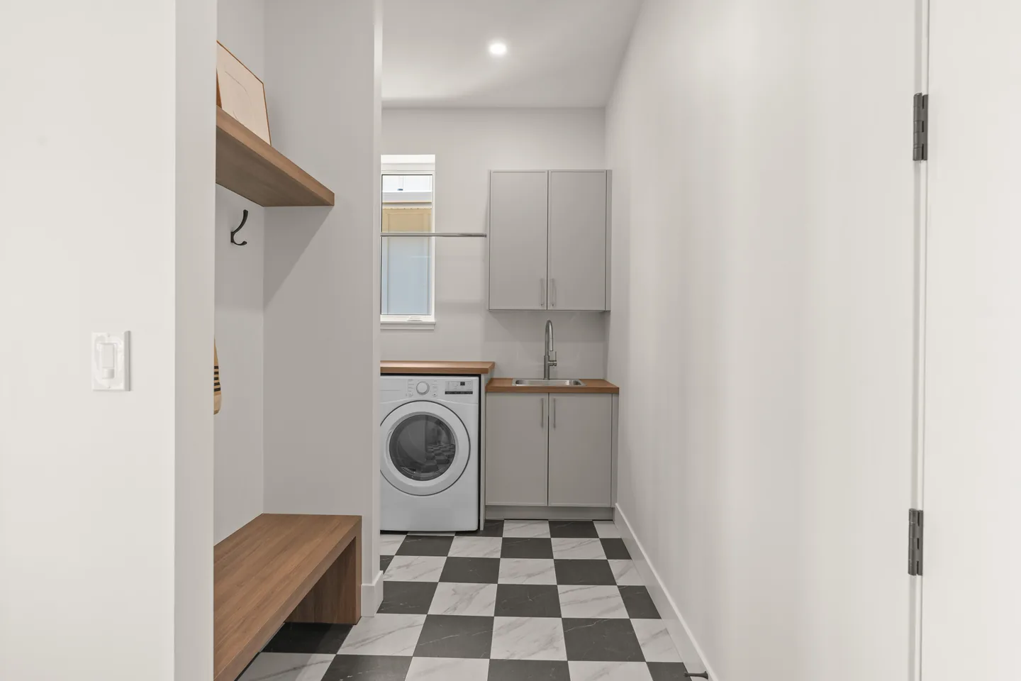 Mudroom bench leading to the laundry room